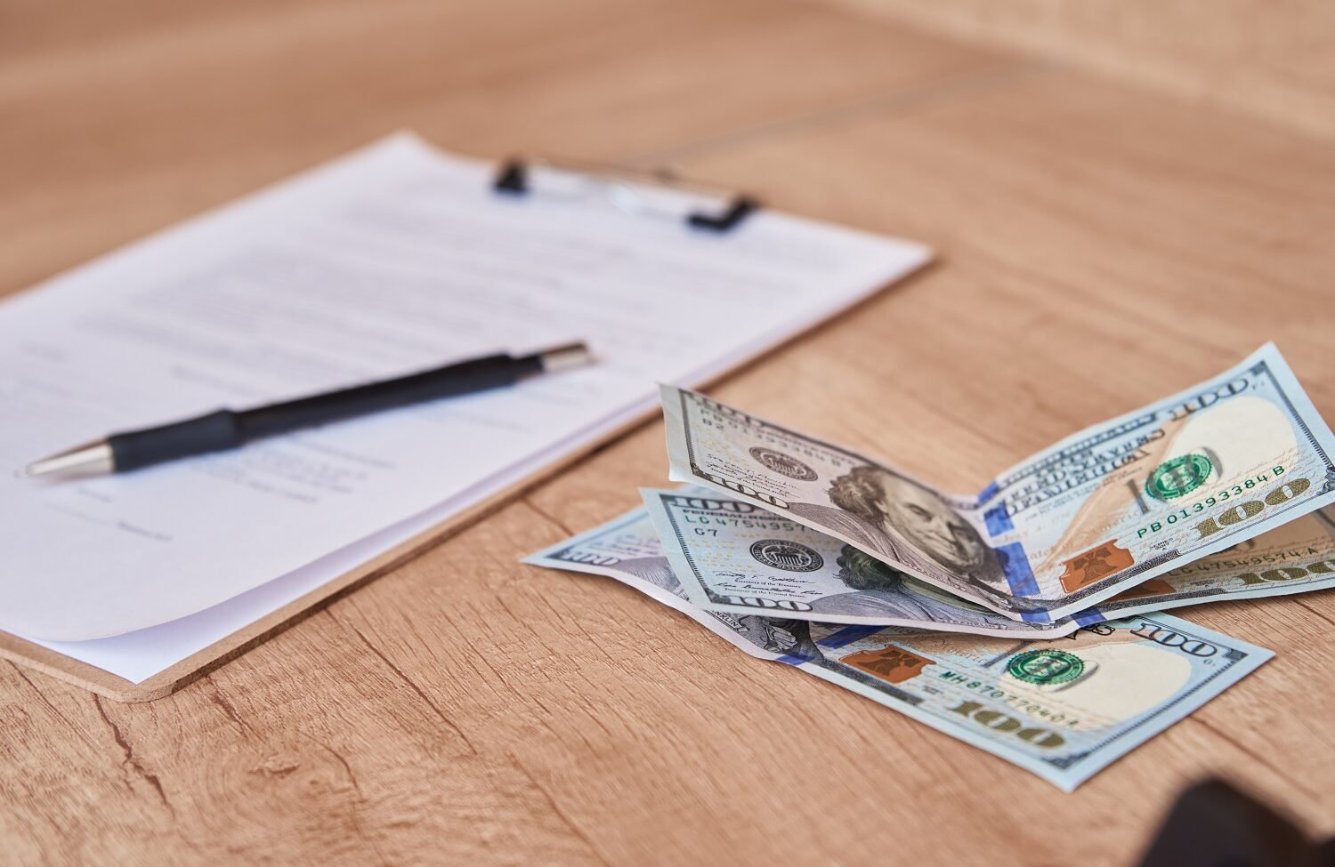 Improving Accessibility: Making University LMS Platforms Inclusive for All document, pen and dollar bills on table, close up